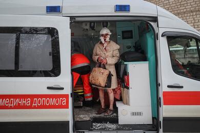 Местная жительница, пострадавшая в результате российской ракетной атаки, стоит в машине скорой помощи. Харьков, Украина, 23 января 2024 года. Фото: Reuters